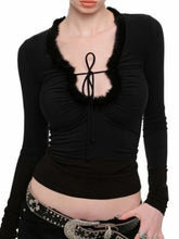 Black long-sleeve top with a unique neckline design
